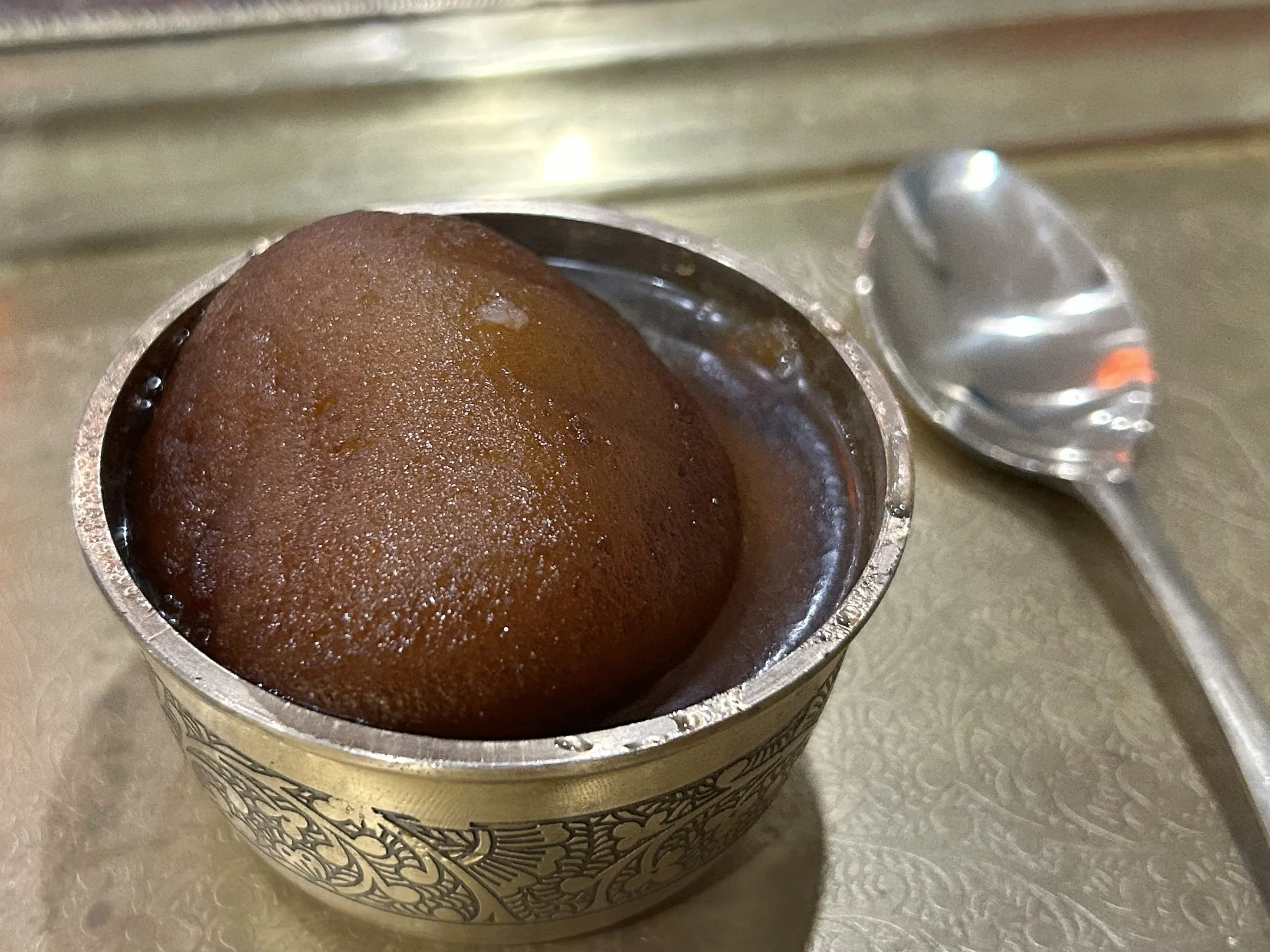 Warm sweet Gulab Jamun in sugar syrup